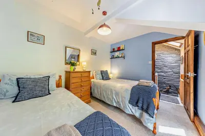 a bedroom with two twin beds and a window at 3 Bed in Machynlleth oc-bow43 in Corris
