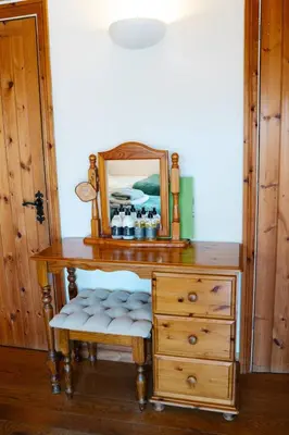 a wooden desk with a mirror and a drawer at Henllys Estate B and B in Llandovery
