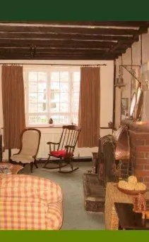 a living room with a couch and a chair at The Horseshoe Guesthouse in Rhayader