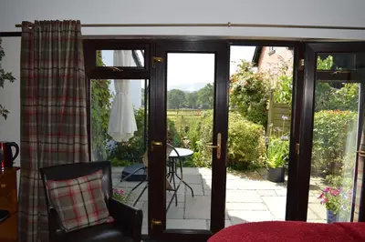 a sliding glass door with a view of a patio at Smithfield Farm Bed & Breakfast in Builth Wells