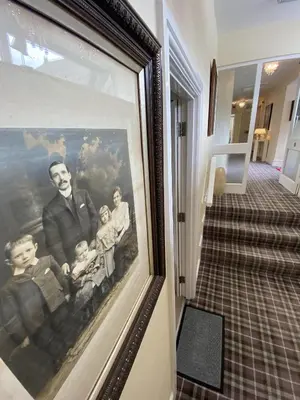 a framed picture of a family on the wall at Rooms at The Usk in Talybont