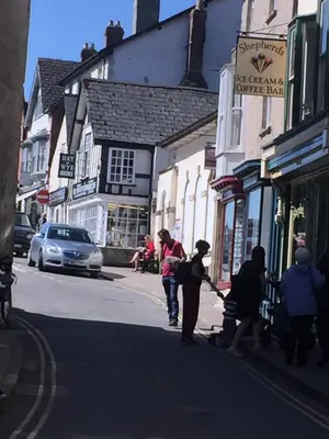 a group of people walking down a city street at The Flat Frank Lewis House in Hay-on-Wye
