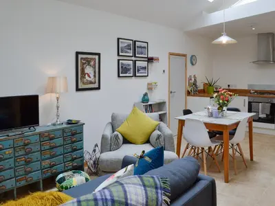 a living room with a couch and a table at Y Gweithdy in Barmouth