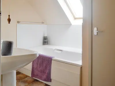 a bathroom with a sink and a bath tub at Green Lane Cottage in Newtown