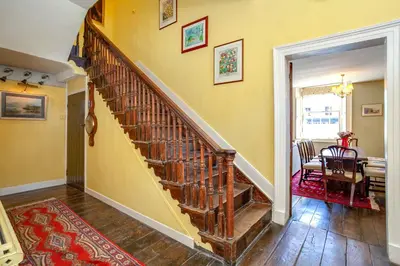 a wooden staircase in a room with a dining room at Colomendy in Montgomery