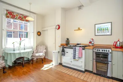 a kitchen with a table and a stove top oven at Colomendy in Montgomery