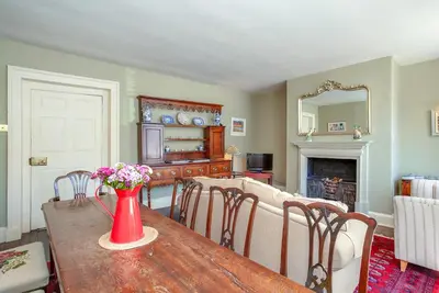 a living room with a table with a vase of flowers on it at Colomendy in Montgomery
