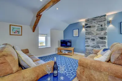a living room with two couches and a tv at 2 Bed in Barmouth oc-bow52 in Llanaber