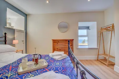 a bedroom with a bed with a tray on it at 2 Bed in Barmouth oc-bow52 in Llanaber