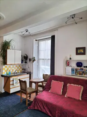 a living room with a red couch and a table at Bryn Awel in Aberystwyth