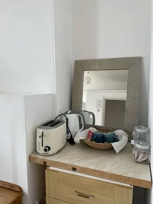 a counter with a toaster and a mirror on it at Bryn Awel in Aberystwyth