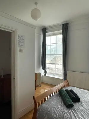 a bedroom with a bed and a large window at Bryn Awel in Aberystwyth