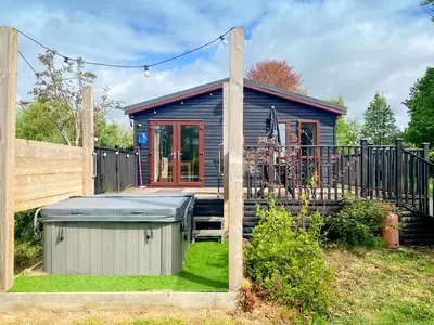 a small house with a gazebo in a yard at Wye Lodge in Aberedw