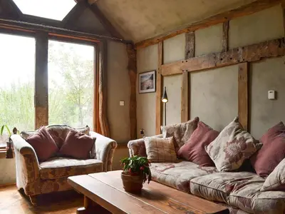 a living room with two couches and a table at The Cart Shed in Kings Pyon