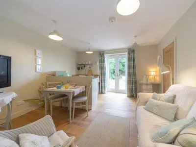 a living room with a couch and a table at Mortimer Trail Mews in Aymestrey