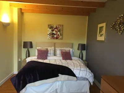 a bedroom with a bed and two lamps at The Granary Country Retreat in Lampeter