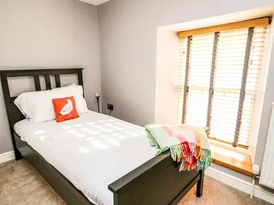 a bedroom with a bed and a window at Water Street in Aberaeron