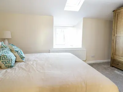 a bedroom with a large bed and a window at Y Cilgwyn in Blaenau-Ffestiniog
