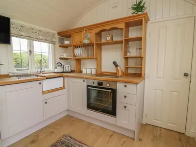 a kitchen with white cabinets and an oven at Hillside View in Saint Harmon