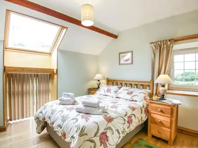a bedroom with a bed and a window at Y Bwthyn in Llanegryn