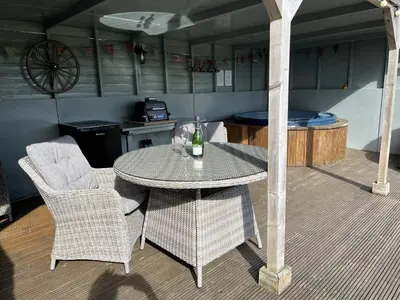 a table and chairs in a room with a kitchen at Shepherds Cabin at Titterstone in Farden