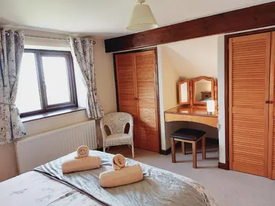 a bedroom with a bed with two towels on it at Waggoners Cottage in Montgomery