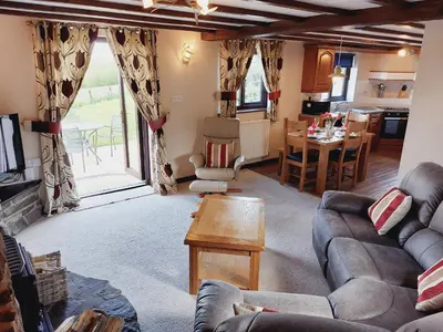 a living room with a couch and a table at Waggoners Cottage in Montgomery