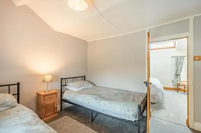 a bedroom with two beds and a window at Gwrtheyrn in Dyffryn