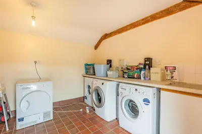 a laundry room with a washer and dryer at Gwrtheyrn in Dyffryn