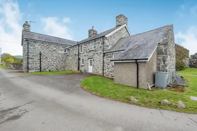 an old stone house on the side of a road at Gwrtheyrn in Dyffryn