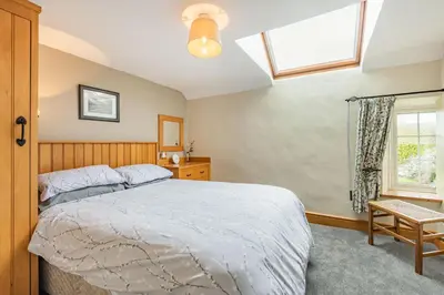 a bedroom with a bed and a window at Gwrtheyrn in Dyffryn