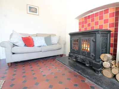 a living room with a fireplace and a couch at School House in Builth Wells
