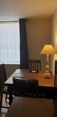 a dining room table with a lamp on top of it at 138a Old Star & Garter in Ludlow