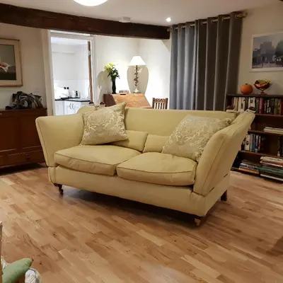 a living room with a yellow couch in a living room at 138a Old Star & Garter in Ludlow