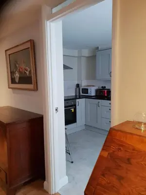 a kitchen with white cabinets and a stove top oven at 138a Old Star & Garter in Ludlow
