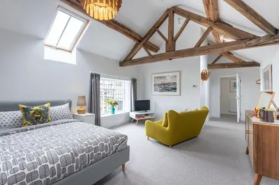 a bedroom with a bed and a yellow chair at The Hall in Bucknell