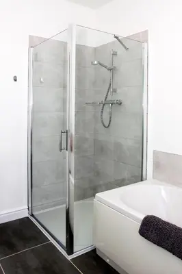 a bathroom with a shower and a bath tub at 2 Yr Hen Fanc in Aberaeron