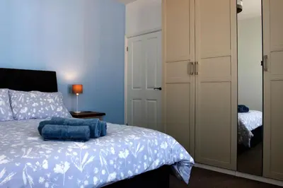 a bedroom with a bed and a closet at 2 Yr Hen Fanc in Aberaeron