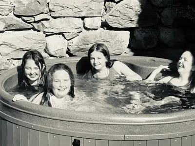 a group of four girls in a hot tub at Hendre Coed Isaf Caravan Park in Barmouth