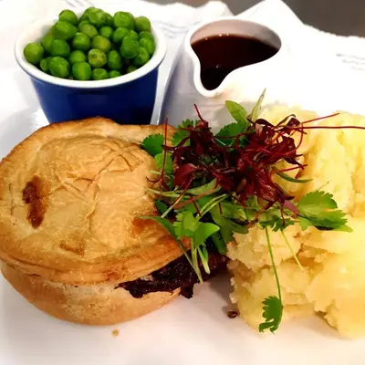a sandwich and mashed potatoes and a bowl of peas at Hendre Coed Isaf Caravan Park in Barmouth