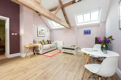 a living room with a couch and a table at The Hayloft, Wall End Farm in Leominster