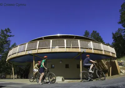 two people riding bikes in front of a building at 3 Bed in Bala oc-bow69 in Bala