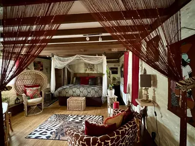 a bedroom with a bed and a couch in a room at Brecon Boutique Breaks Wild Land in Sennybridge