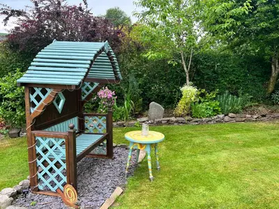 a small bird house and a table in a yard at Brecon Boutique Breaks Wild Land in Sennybridge