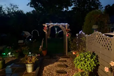 a garden at night with an arch and lights at Brecon Boutique Breaks River Run in Sennybridge