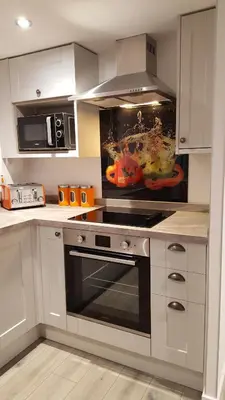 a kitchen with white cabinets and a stove top oven at Ruth's Refresh Country Retreat with Private Hot Tub & Stunning Views in Shrewsbury
