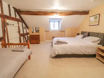 a large bedroom with two beds and a window at Pengwern in Pennant-Melangell