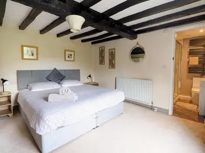 a bedroom with a large white bed in a room at Pengwern in Pennant-Melangell