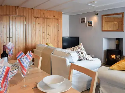 a living room with a couch and a table at Seadrift in New Quay