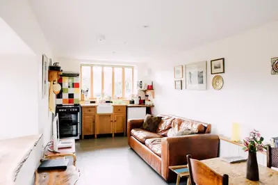 a living room with a couch and a table at The Barn at Ty Beic in Bala